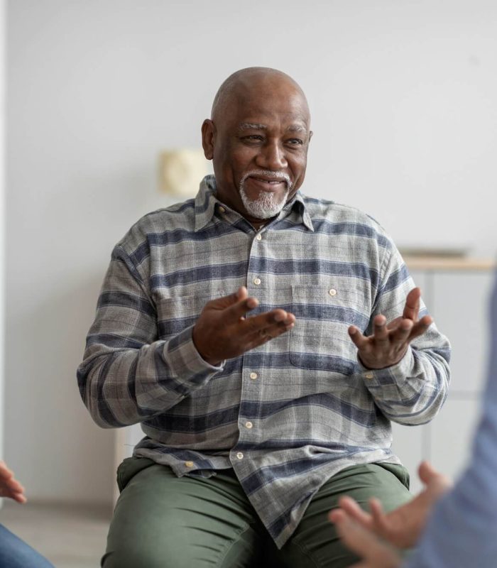 cheerful-african-american-elderly-man-having-conversation-with-coach.jpg