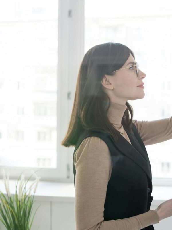 elegant-coach-with-smartphone-writing-down-on-whiteboard-during-presentation.jpg